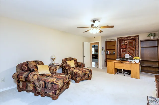 a living room with furniture gym equipment and a chandelier