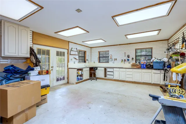 a living room with stainless steel appliances furniture and a kitchen view
