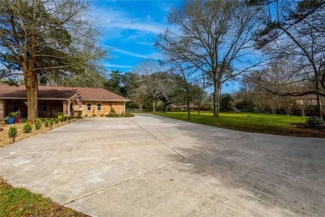 a view of house with outdoor space and tree