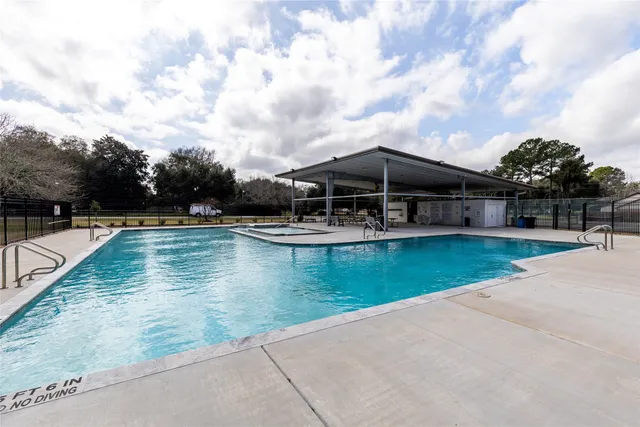 a view of a house with swimming pool and sitting area