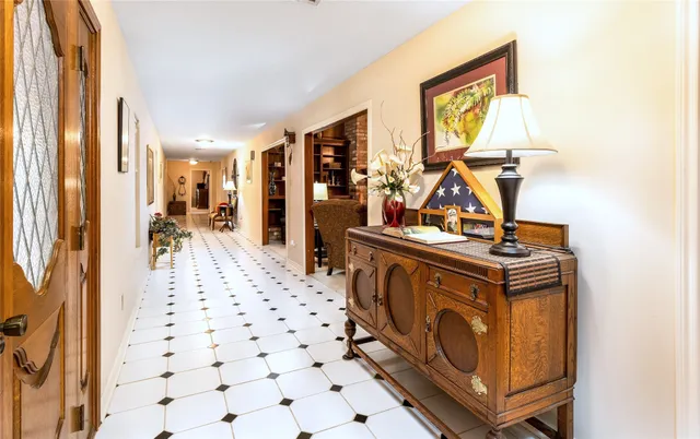 a view of a hallway with wooden floor and windows