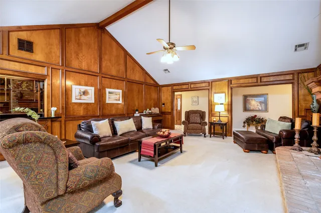 a living room with furniture ceiling fan and a window