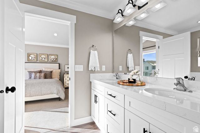 8808 South Cy's Park, Unit 5 Sandy, UT 84094 - Photo 6 of 9 Ensuite bathroom featuring double vanity, ornamental molding, and recessed lighting