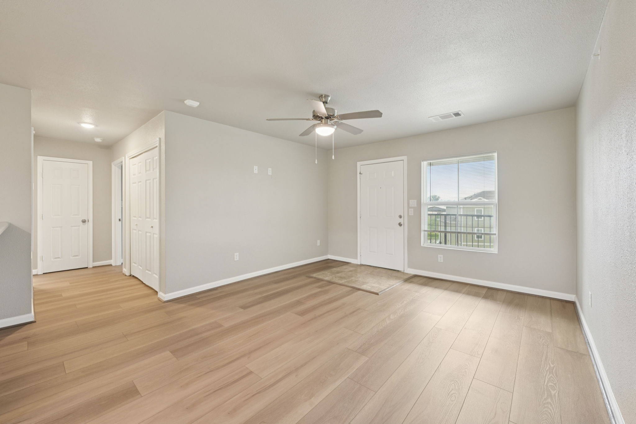 254 Plez Morgan Drive, Unit F Montgomery, TX 77356 - Photo 1 of 31 a view of an empty room with wooden floor and a window