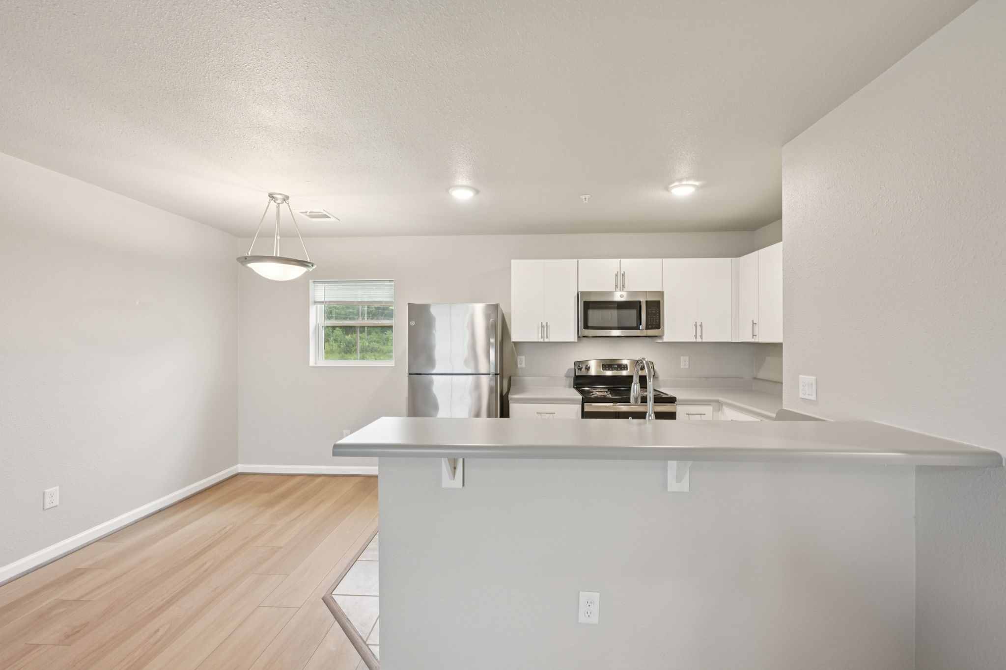 254 Plez Morgan Drive, Unit F Montgomery, TX 77356 - Photo 11 of 31 a kitchen with stainless steel appliances granite countertop a sink and a stove