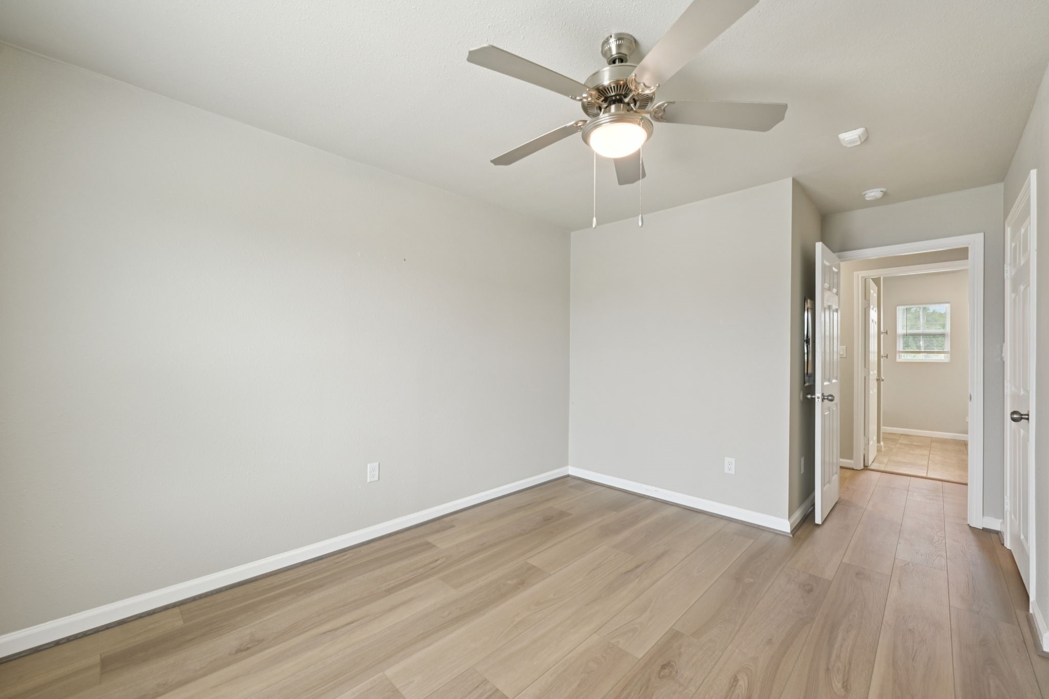 254 Plez Morgan Drive, Unit F Montgomery, TX 77356 - Photo 29 of 31 wooden floor in an empty room with a window