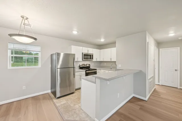 a kitchen with stainless steel appliances a refrigerator sink and stove