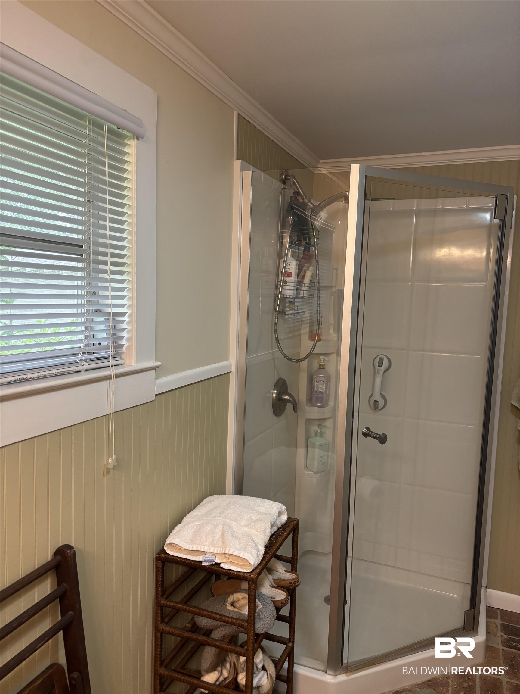 216 West Orange Avenue Foley, AL 36535 - Photo 12 of 37 Full bathroom with a stall shower, wainscoting, and ornamental molding