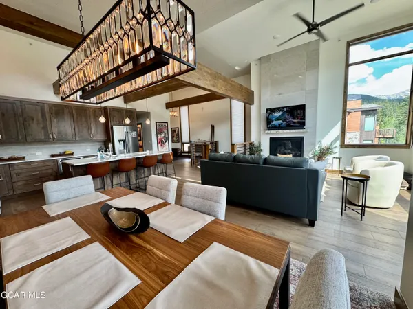 a living room with furniture kitchen view and a large window