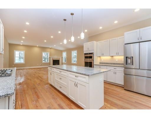 46 Colburn Street Westwood, MA 02090 - Photo 9 of 30 a kitchen with stainless steel appliances granite countertop a refrigerator a sink dishwasher a stove and white countertops with wooden floor