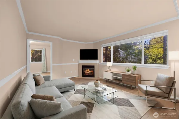 a living room with furniture a fireplace and a flat screen tv