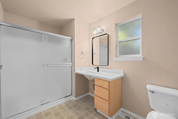 a bathroom with a toilet sink and mirror