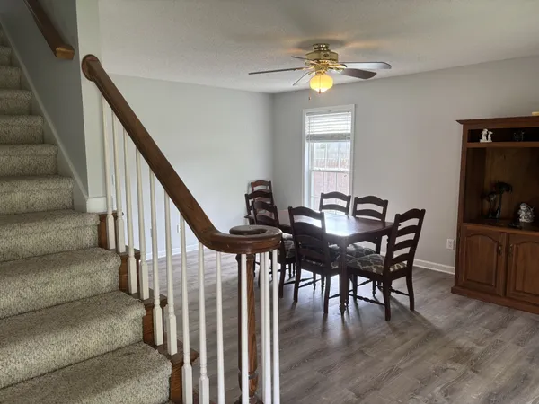 a view of a dining room with furniture and a chandelier