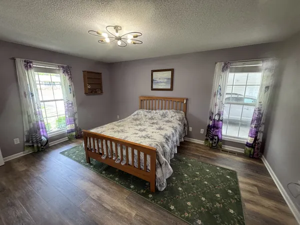 a bed sitting in a bedroom next to a window