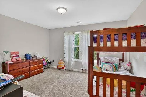 a bedroom with furniture and a window
