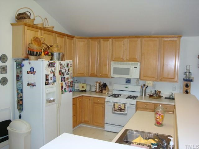 5124 Long Neck Court Raleigh, NC 27604 - Photo 3 of 12 Maple Cabinets , wrap bar top for serving those family meals overlooks the Huge breakfast area / Florida room .