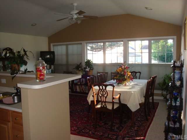 5124 Long Neck Court Raleigh, NC 27604 - Photo 4 of 12 Looking at the Breakfast room from the kitchen , a wall of windows with top/bottom opening shades and doorway to the covered area on the back deck!