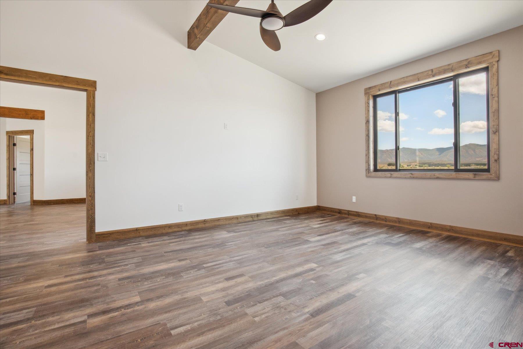 8847 Road 26.7 Cortez, CO 81321 - Photo 23 of 29 a view of an empty room with wooden floor and a window