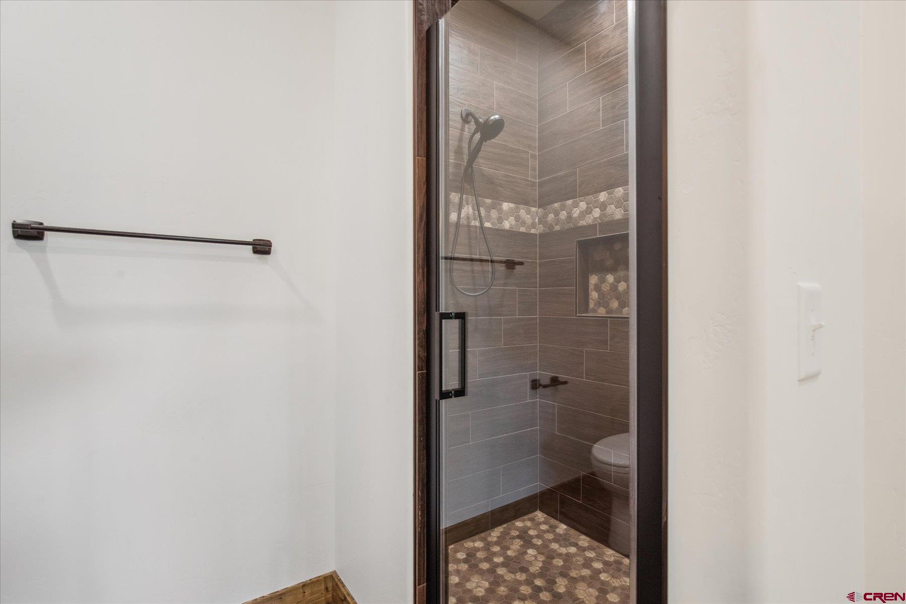 8847 Road 26.7 Cortez, CO 81321 - Photo 25 of 29 a bathroom with a glass shower door