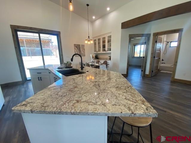 8847 Road 26.7 Cortez, CO 81321 - Photo 8 of 29 a large kitchen with kitchen island a stove a sink and a large countertops with wooden floor