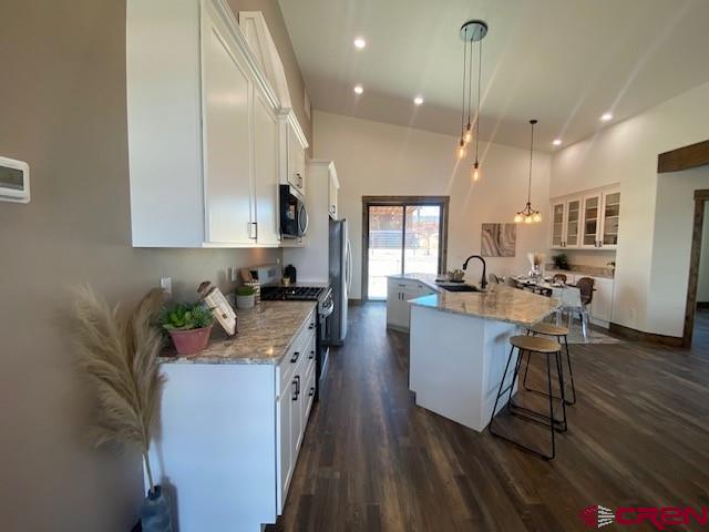 8847 Road 26.7 Cortez, CO 81321 - Photo 9 of 29 a kitchen with stainless steel appliances granite countertop sink stove refrigerator dining table and chairs
