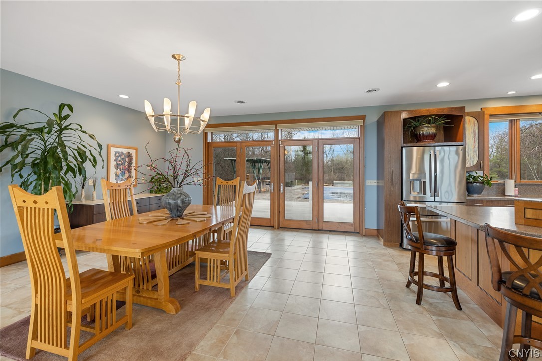 6687 Beach Road Camillus, NY 13209 - Photo 14 of 50 Doors at far end of dining area lead to expansive