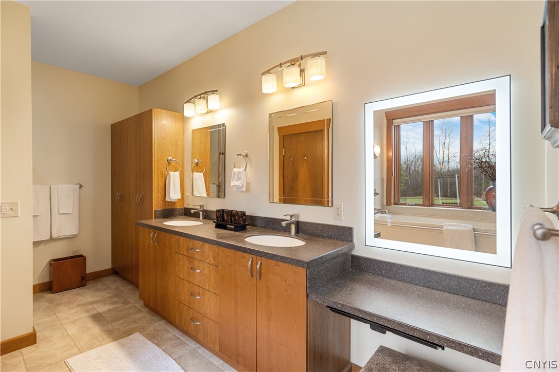 6687 Beach Road Camillus, NY 13209 - Photo 20 of 50 Primary bath with dual sinks, fog free mirror, wal