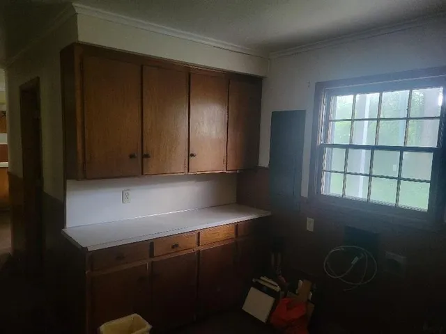 a room with a window and cabinets