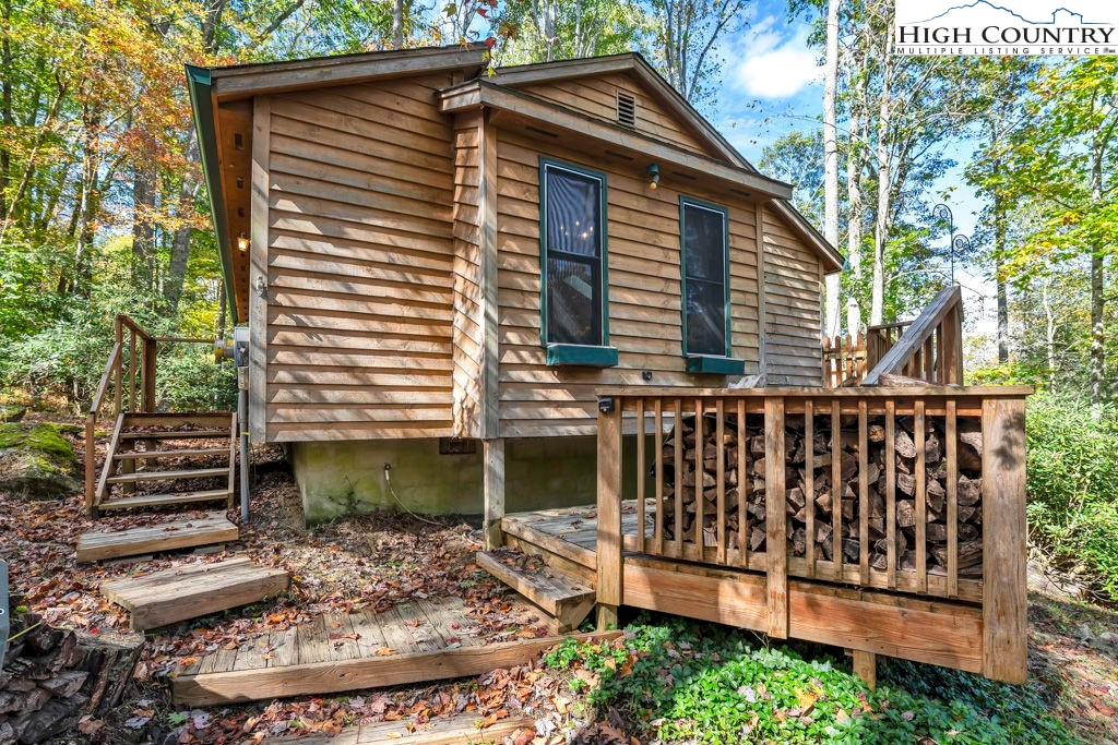 180 Wild Blackberry Hill Road Boone, NC 28607 - Photo 1 of 30 a view of a house with a small yard and wooden fence