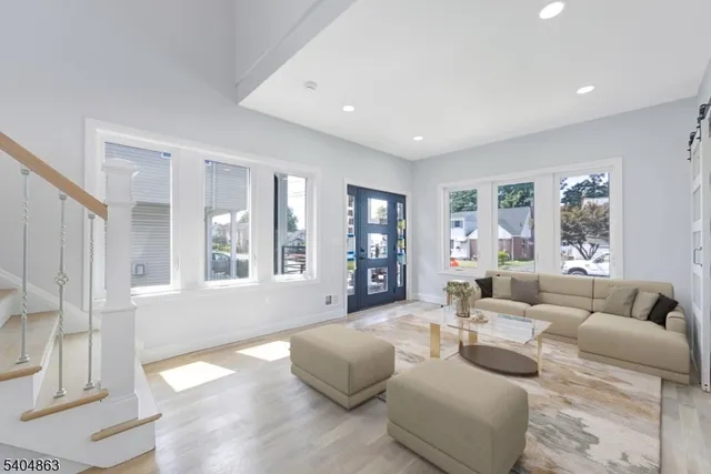 a living room with furniture and large windows