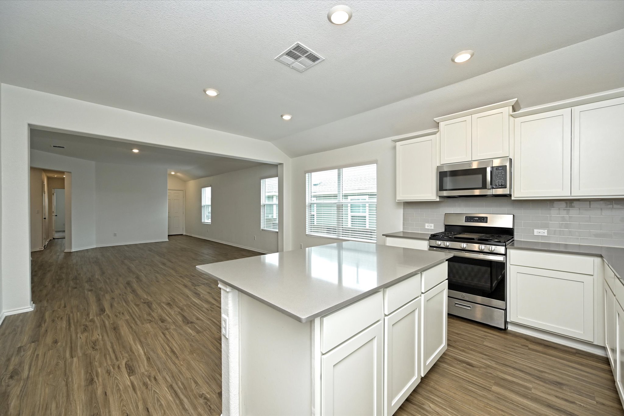 180 Madrid Kyle, TX 78640 - Photo 15 of 32 a kitchen with granite countertop a stove and a sink