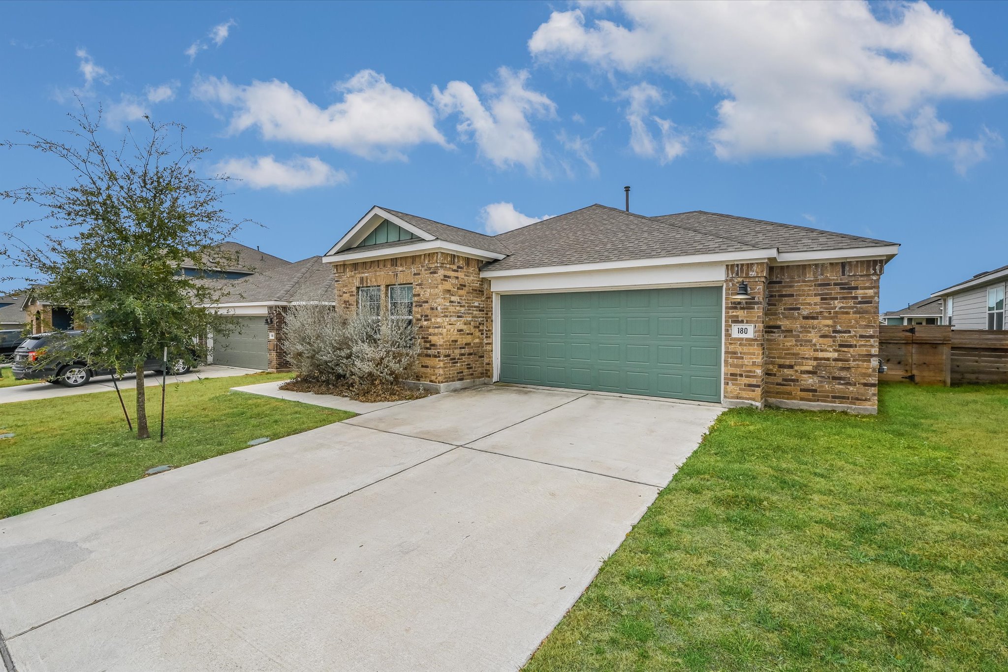 180 Madrid Kyle, TX 78640 - Photo 2 of 32 a front view of a house with garden