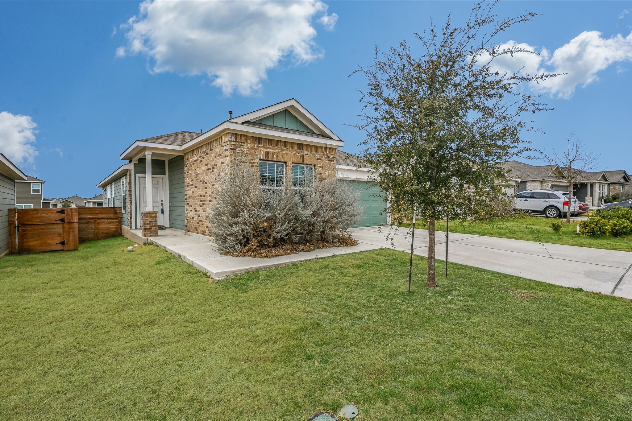 180 Madrid Kyle, TX 78640 - Photo 31 of 32 a front view of house with yard and trees in the background