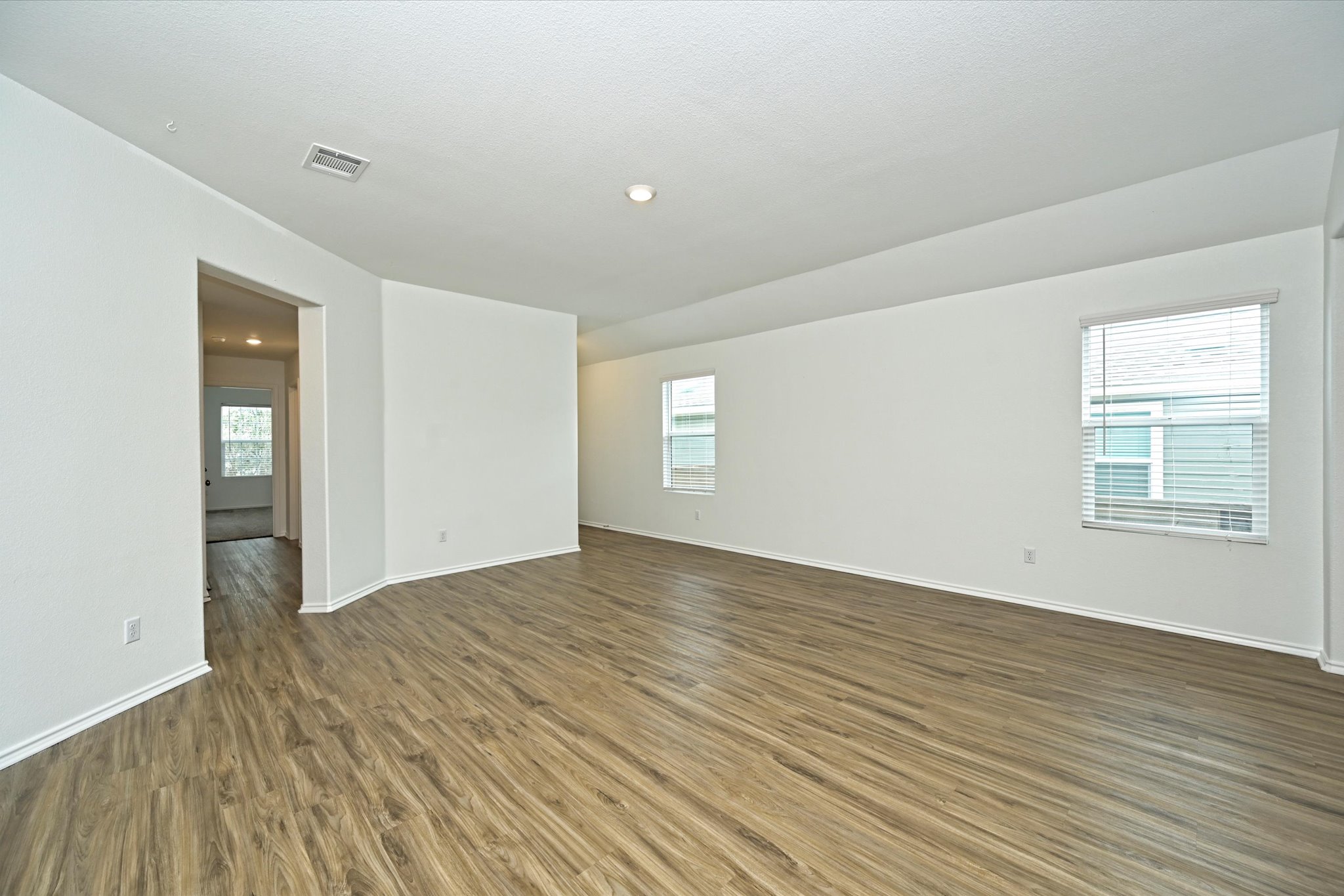180 Madrid Kyle, TX 78640 - Photo 9 of 32 wooden floor in an empty room with a window