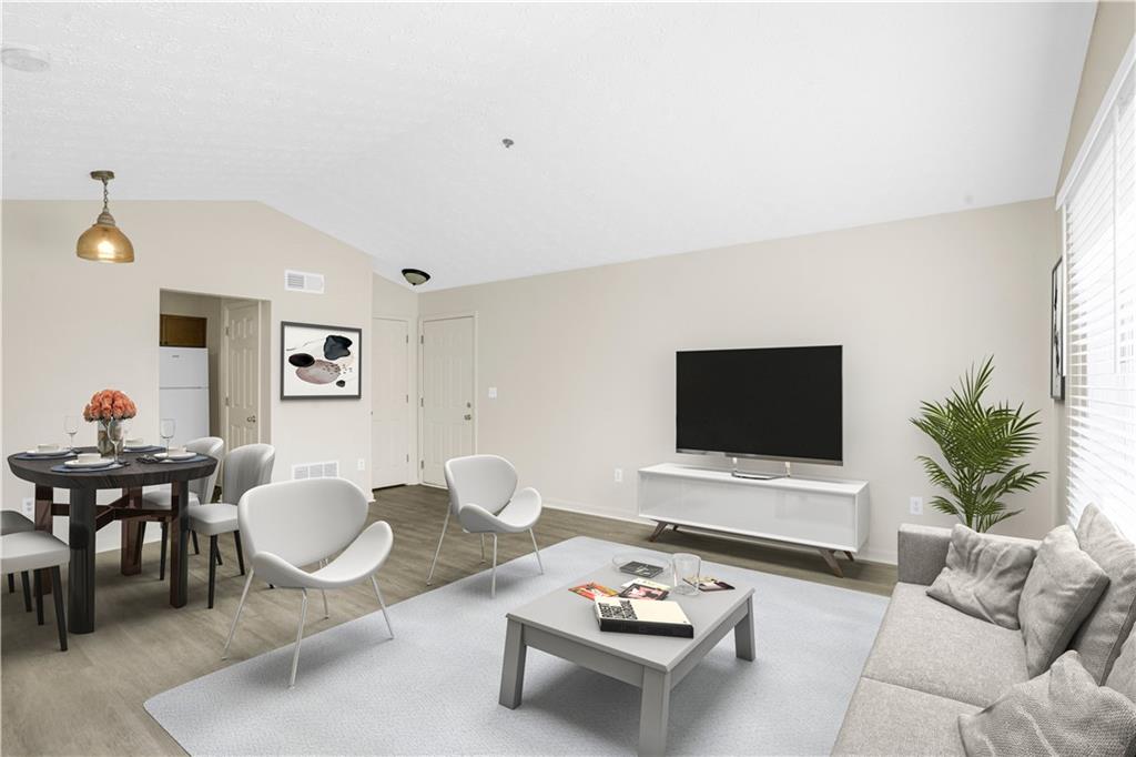 a living room with furniture a rug and a flat screen tv