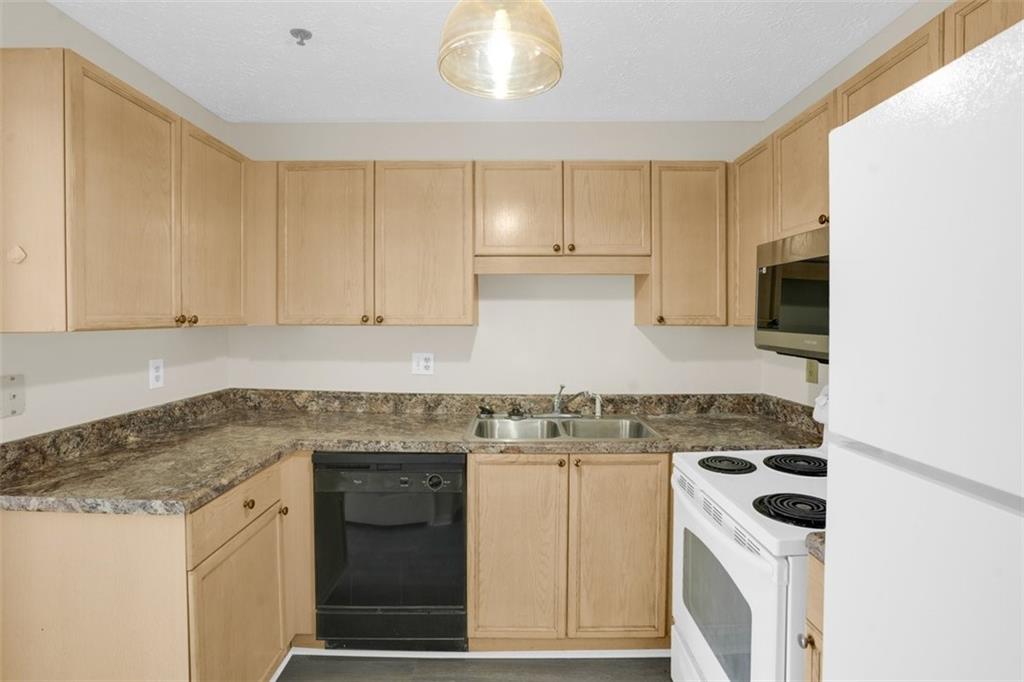 235 Bentley Place Tucker, GA 30084 - Photo 11 of 22 a kitchen with granite countertop white cabinets and white appliances