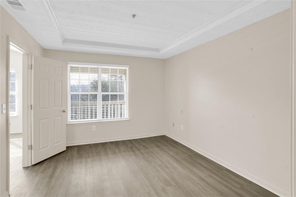 235 Bentley Place Tucker, GA 30084 - Photo 13 of 22 an empty room with wooden floor and windows