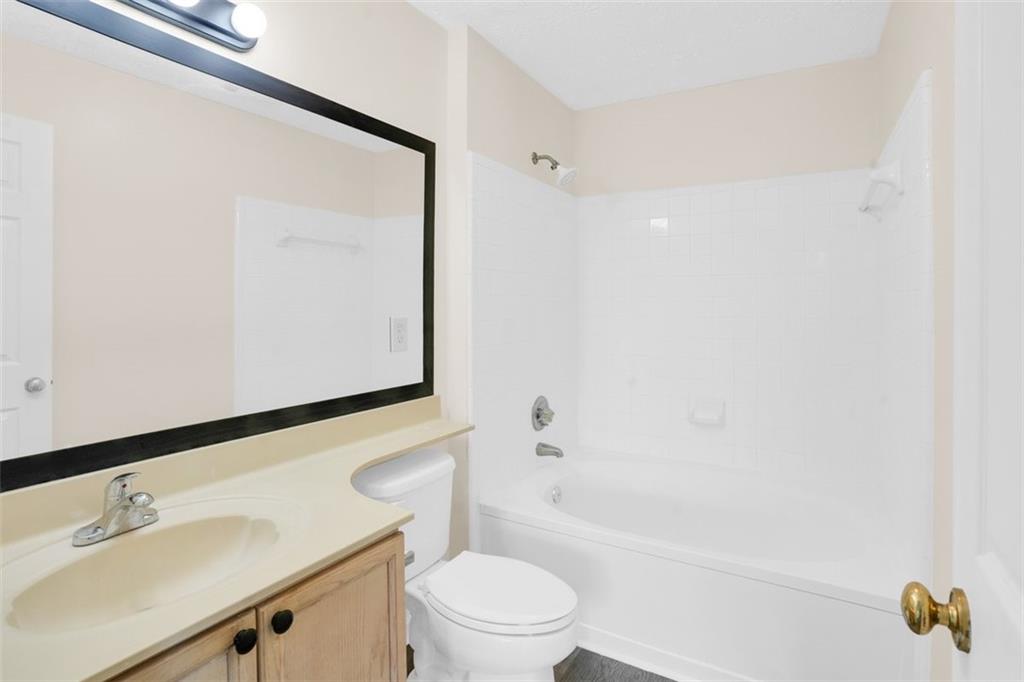 235 Bentley Place Tucker, GA 30084 - Photo 15 of 22 a bathroom with a bathtub shower sink vanity and toilet