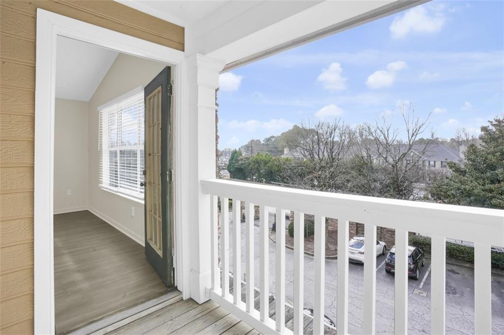 235 Bentley Place Tucker, GA 30084 - Photo 17 of 22 a view of a balcony with wooden fence and floor