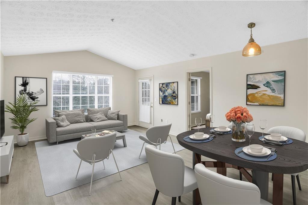 235 Bentley Place Tucker, GA 30084 - Photo 2 of 22 a view of a dining room with furniture and wooden floor