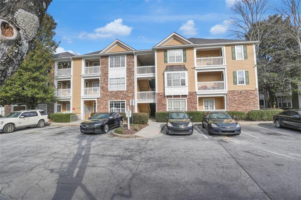 235 Bentley Place Tucker, GA 30084 - Photo 21 of 22 a view of a brick house with many windows and couches chairs
