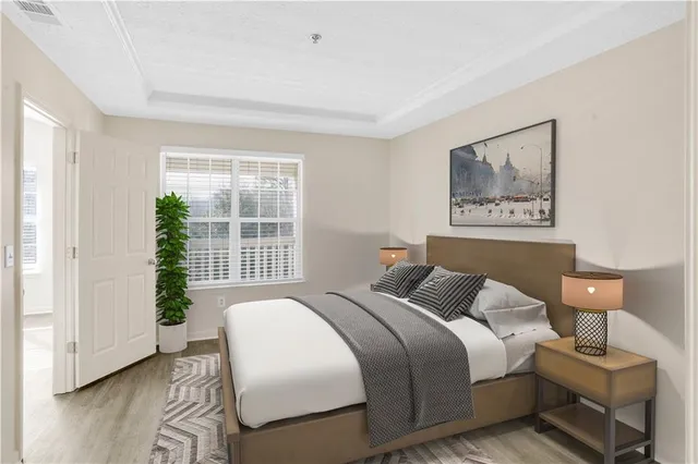 a bedroom with a bed and a large window