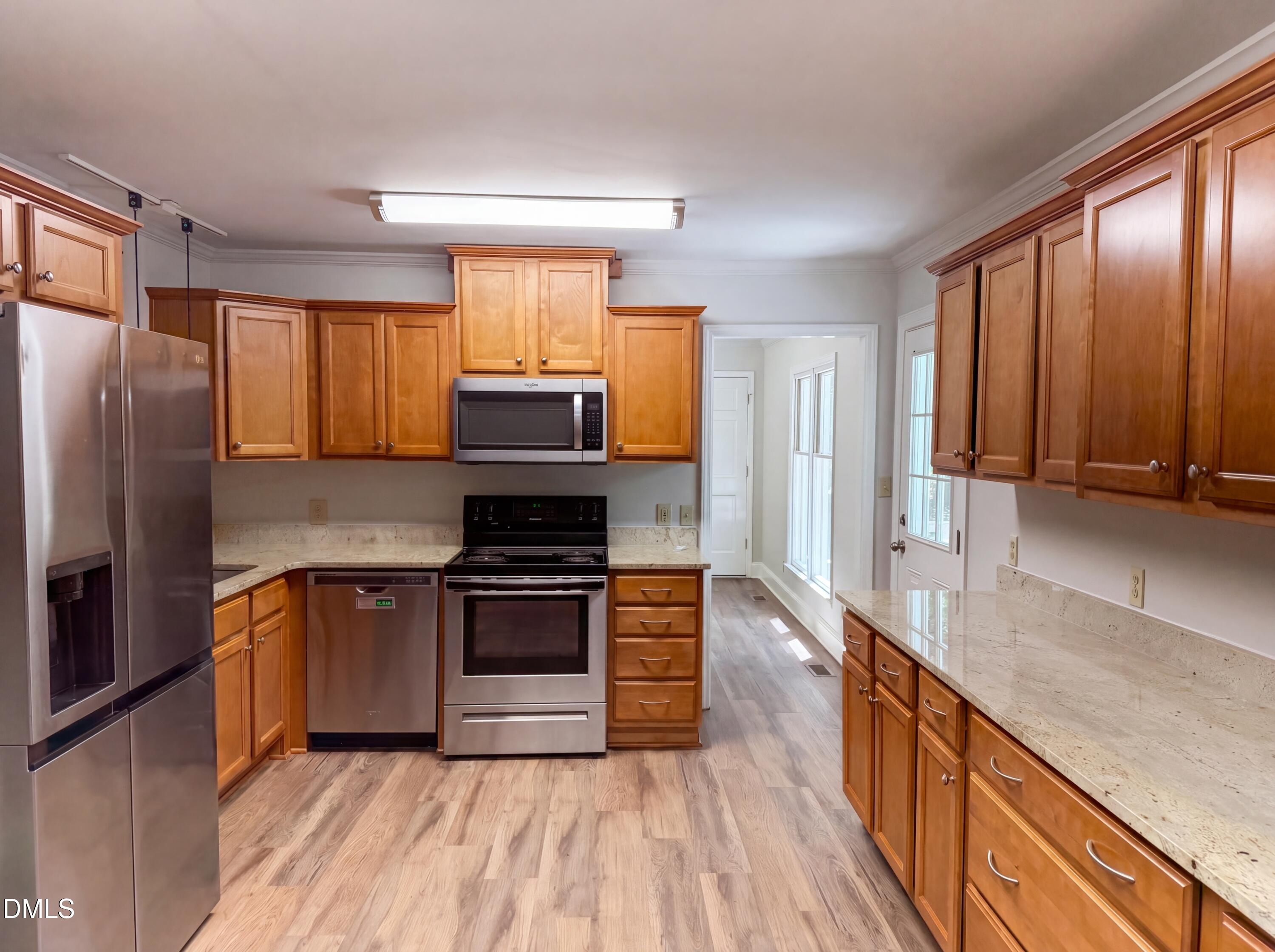 102 Lakeside Farm Road Zebulon, NC 27597 - Photo 8 of 18 a kitchen with stainless steel appliances granite countertop a refrigerator a sink dishwasher stove and oven