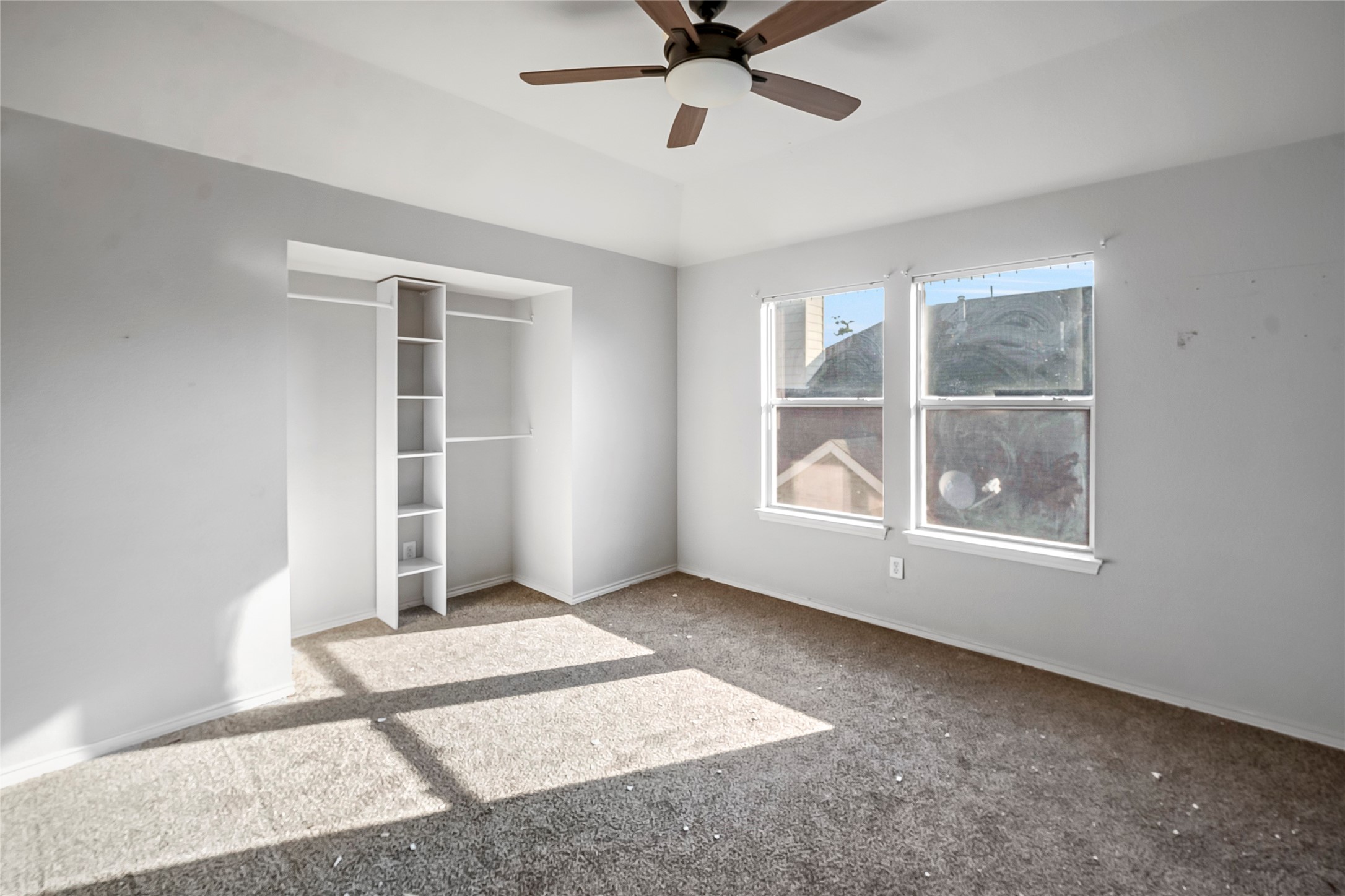 7403 Fall Springs Lane Humble, TX 77396 - Photo 11 of 16 an empty room with windows and closet