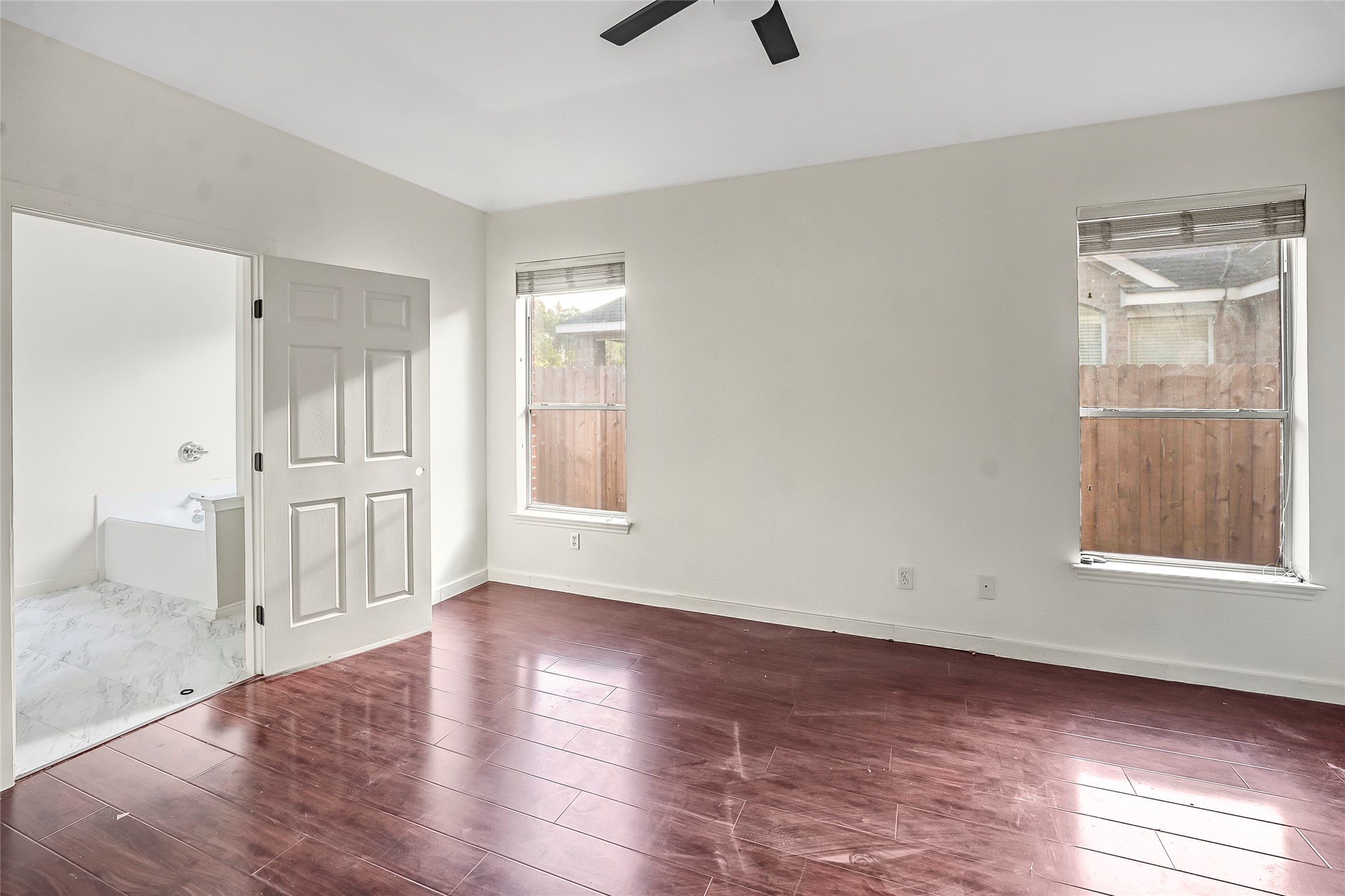 7403 Fall Springs Lane Humble, TX 77396 - Photo 7 of 16 an empty room with wooden floor cabinet and windows