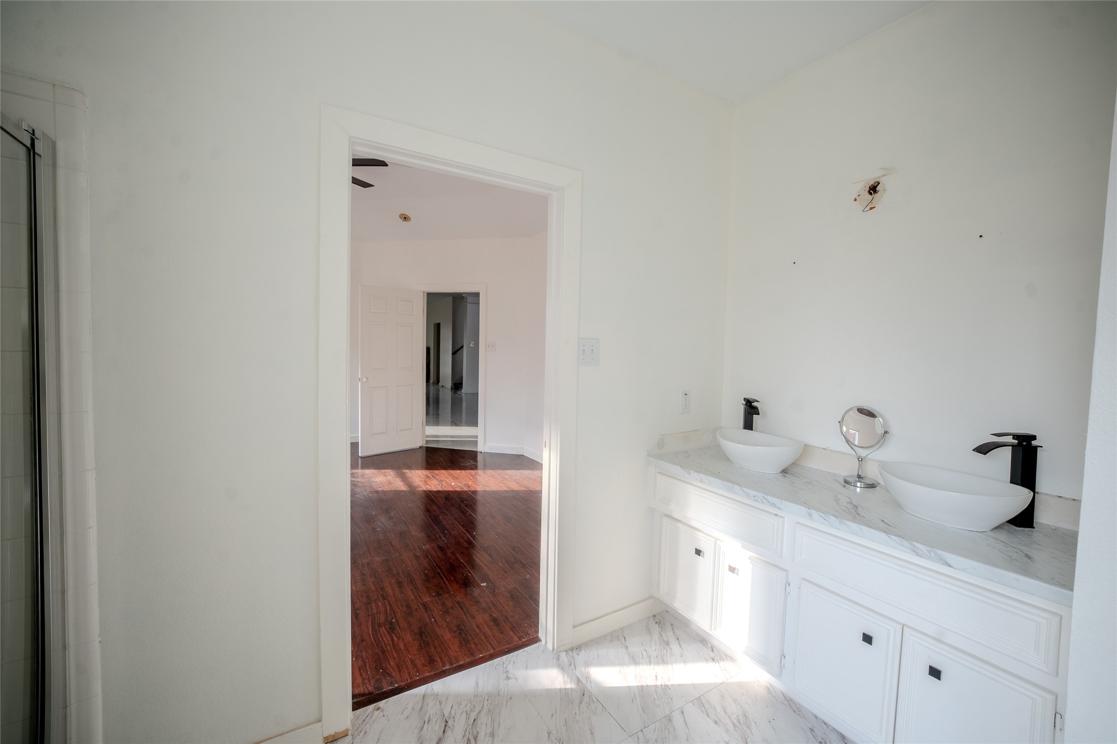 7403 Fall Springs Lane Humble, TX 77396 - Photo 9 of 16 a en suite bathroom with a granite countertop sink and a mirror