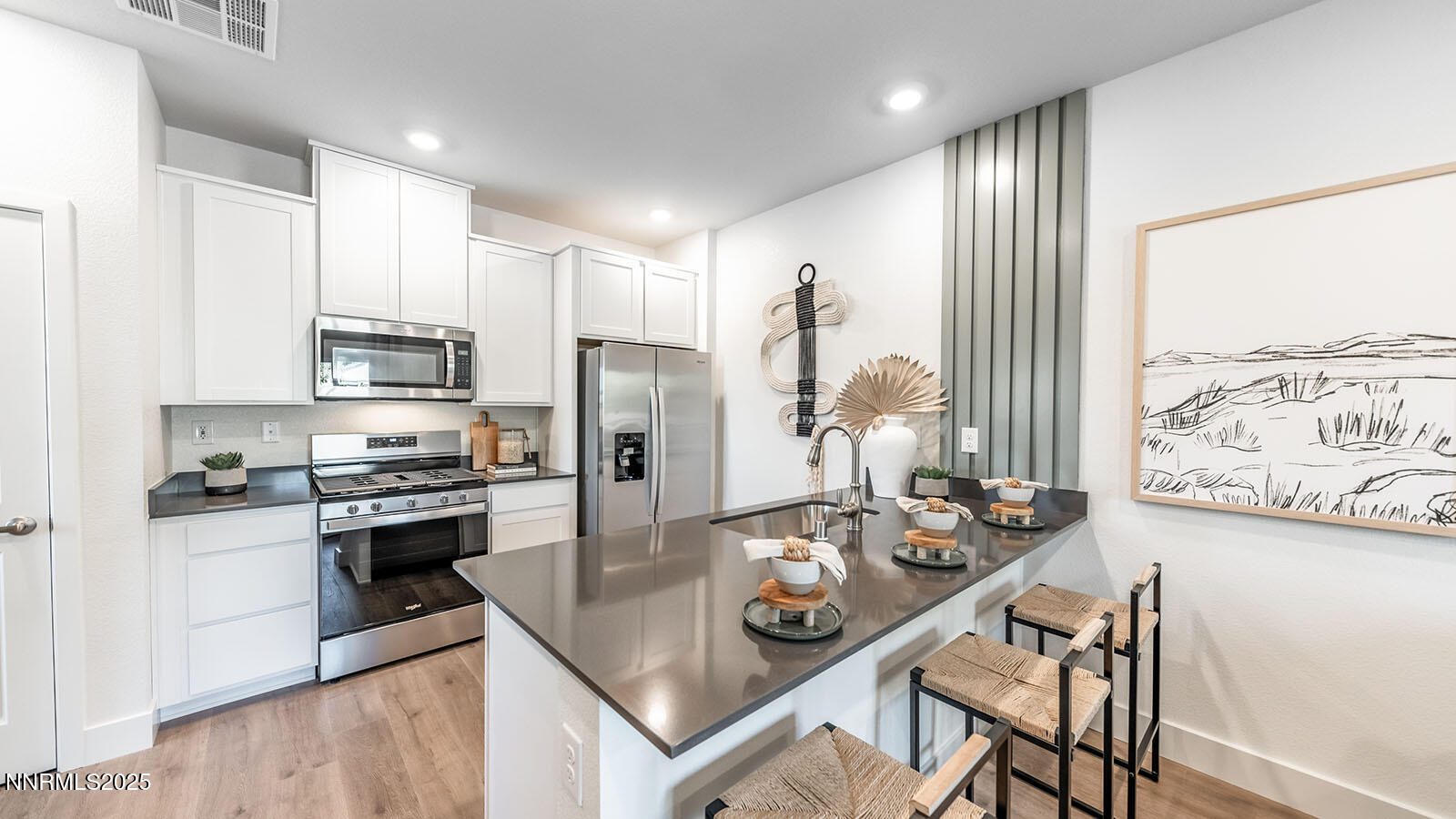 1641 Icelandic Way Reno, NV 89523 - Photo 6 of 25 a kitchen with stainless steel appliances granite countertop a stove top oven a sink a refrigerator and white cabinets