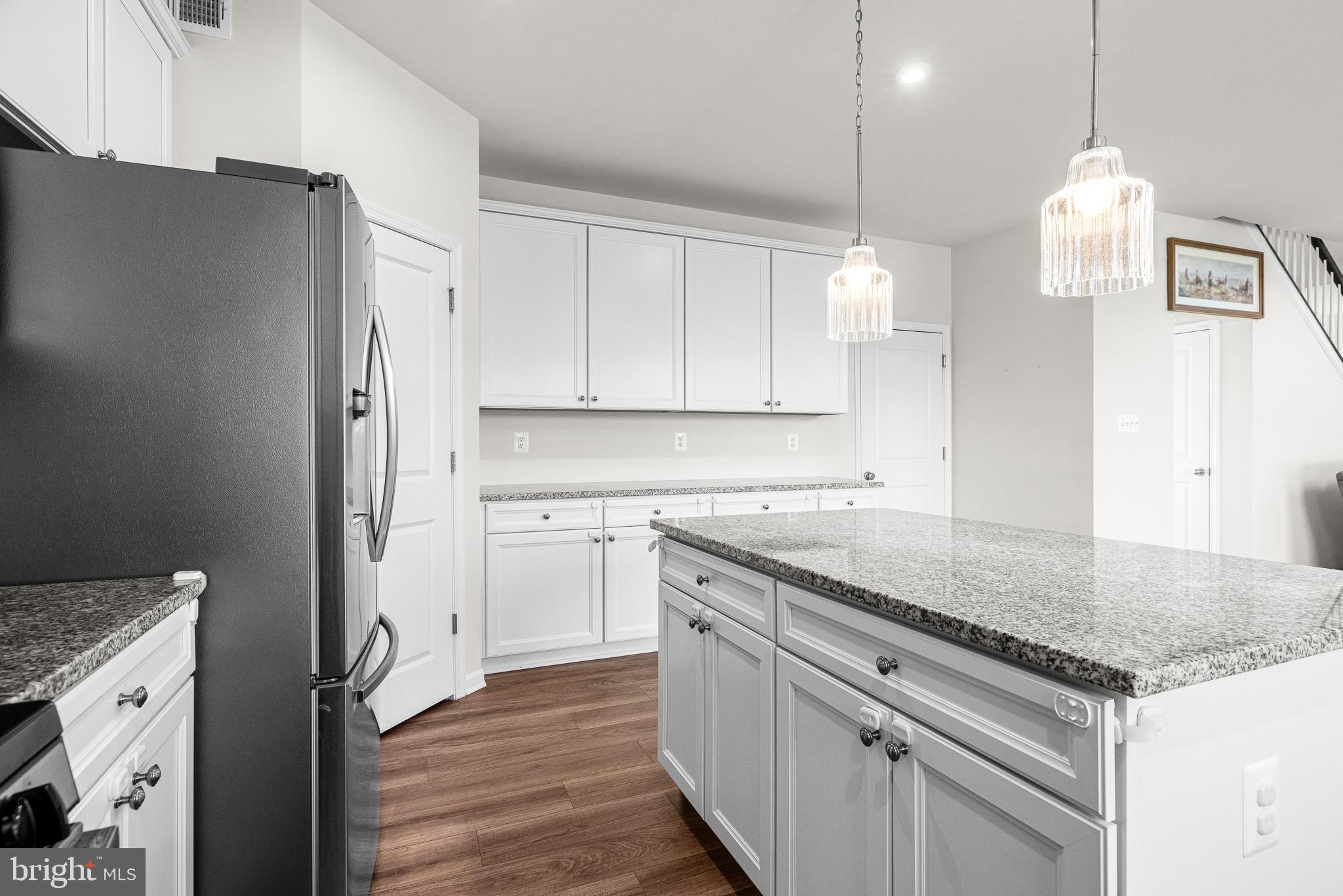 1022 Fawn Haven Walk Dover, DE 19901 - Photo 13 of 46 a kitchen with stainless steel appliances granite countertop a sink a stove and a refrigerator