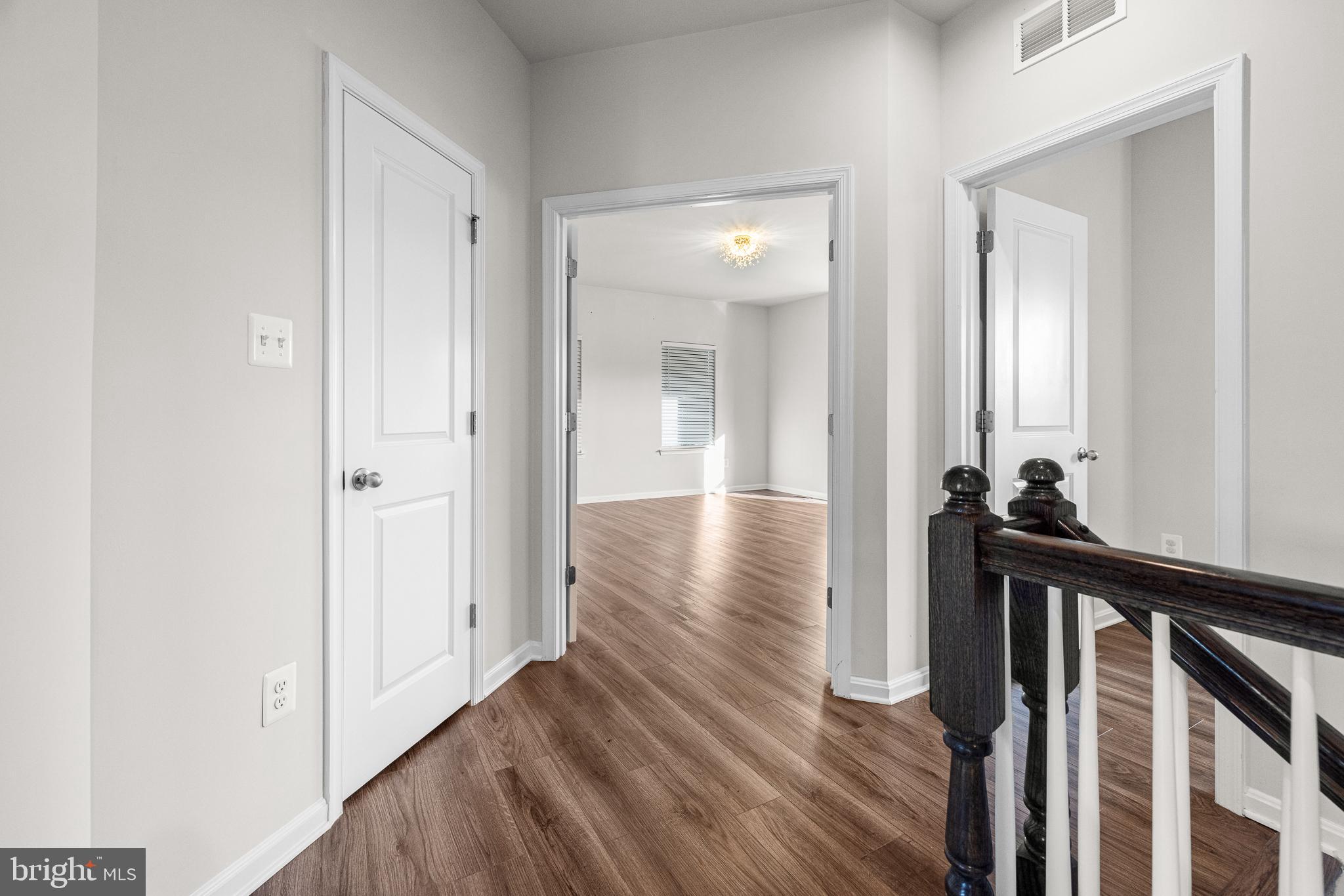 1022 Fawn Haven Walk Dover, DE 19901 - Photo 18 of 46 a view of a hallway view with wooden floor and staircase