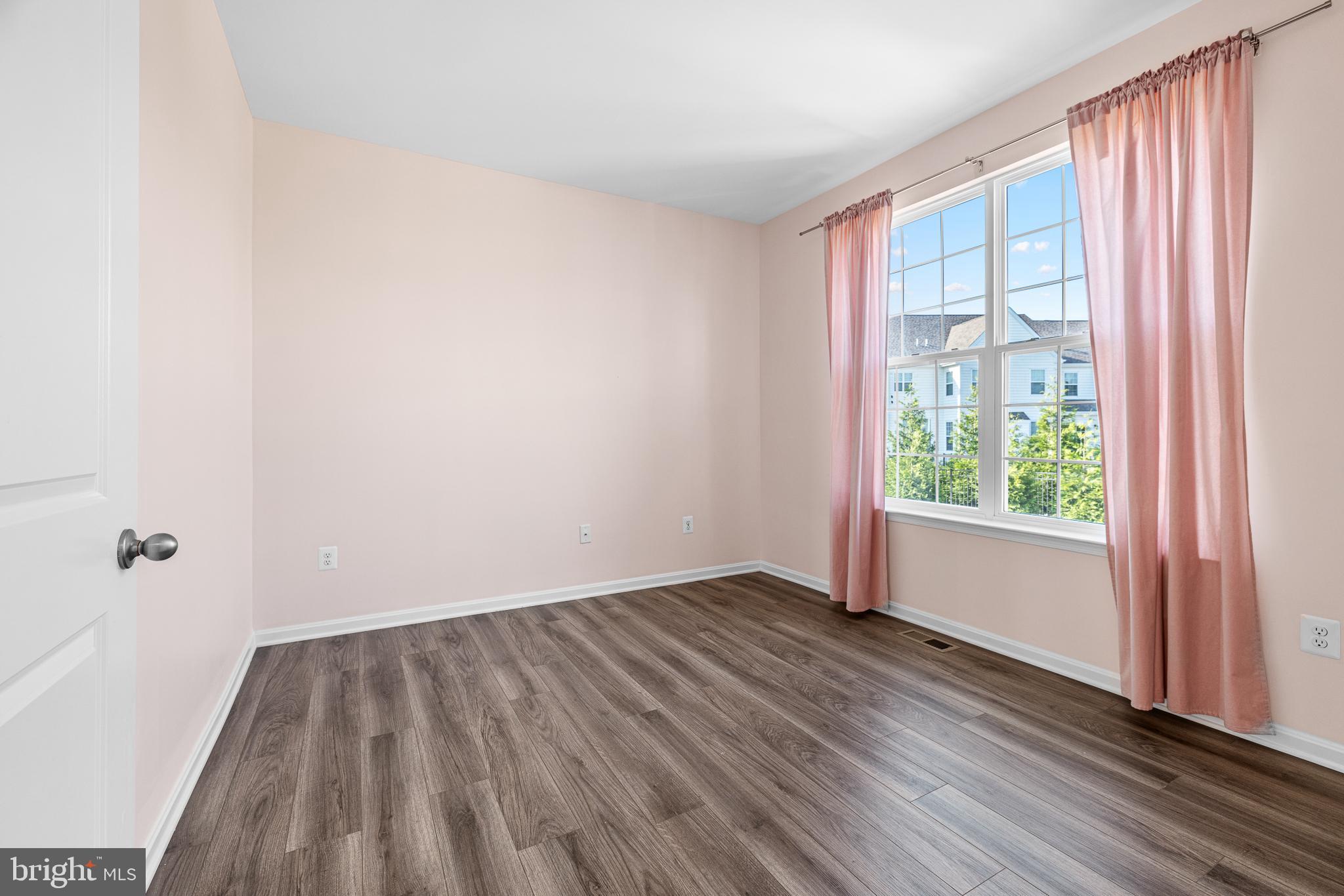 1022 Fawn Haven Walk Dover, DE 19901 - Photo 19 of 46 a view of a room with wooden floor and a window